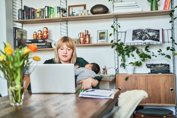 istock Single mother working at home while carrying baby 1459326554