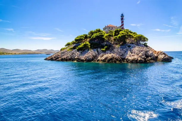 Croatian rocky island with lighthouse on Vela Sestrica near Kornati, Adriatic Sea, Croatia, landscape. Vacation travel concept.