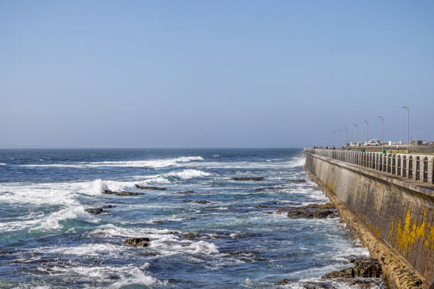 Cape Town, South Africa - December 9th 2022: Pier at the rocky coast of the Atlantic Ocean