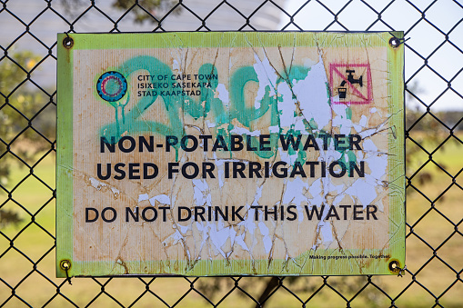 Cape Town, South Africa - December 9th 2022: Poster on a fence with information about the quality of the irrigation water - relevant in a country with shortage of drinking water and many homeless people