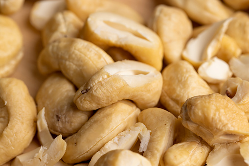 scattered pile of cashew nuts, fresh cashew nuts on the table