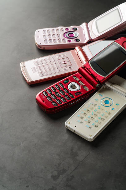 istock Old used cell phone on dark background 1459328336