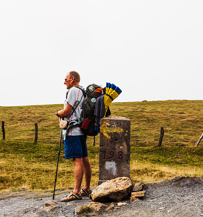 French Pyrenees, France - July 28, 2022: Pilgrim from behind along the Camino de Santiago. Path of the way of St James in the French Pyrenees