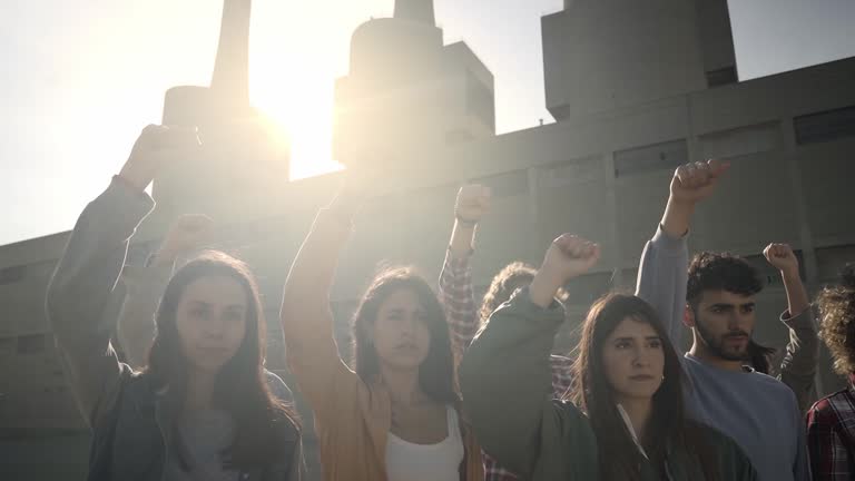 Slow motion of a group of activists protesting outdoors in the city. People demonstration for the rights