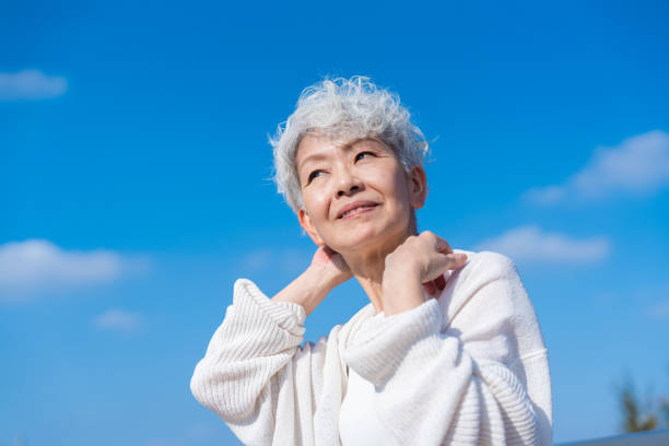 istock Senior woman stretching under the blue sky 1459328722