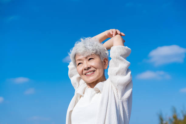 istock Senior woman stretching under the blue sky 1459328734