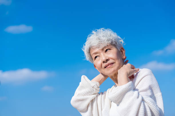 istock Senior woman stretching under the blue sky 1459328735