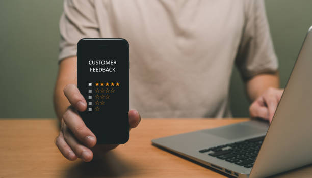 istock Selective focus at finger of business man while point finger to choose feedback on excellent customer service with five star score with smile. Service evaluation concept with futuristic icon. 1459329607