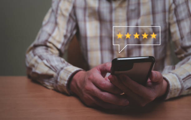 istock Selective focus at finger of business man while point finger to choose feedback on excellent customer service with five star score with smile. Service evaluation concept with futuristic icon. 1459329614