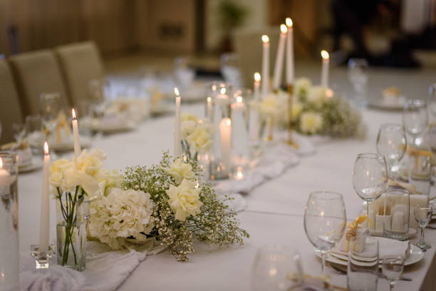 istock Table setting, serving closeup. Wedding setup detail. Banquet decoration in hall restaurant. Luxury reception. Festive table covered tablecloth, decorated composition flowers and candles in party area 1459329671