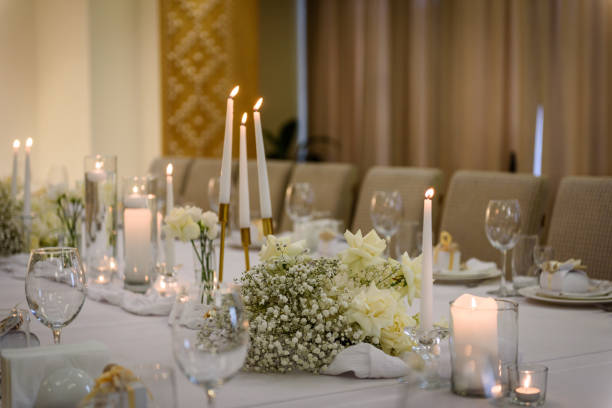 istock Table setting, serving closeup. Wedding setup detail. Banquet decoration in hall restaurant. Luxury reception. Festive table covered tablecloth, decorated composition flowers and candles in party area 1459329690