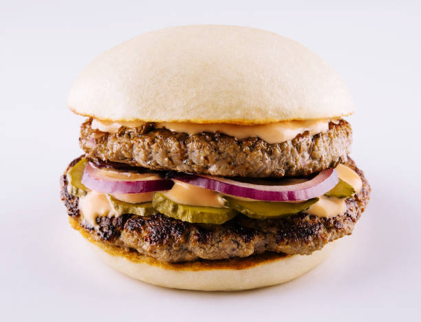istock hamburger with two cutlets, pickled cucumbers and melted cheese 1459331346