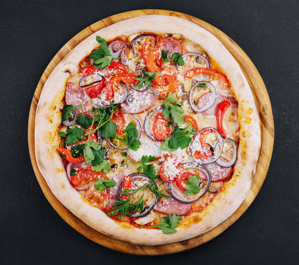 istock Delicious pizza isolated on a black background 1459331413