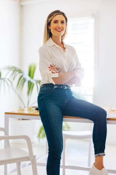 istock Female entrepreneur smiling at the camera in a modern office 1459331618
