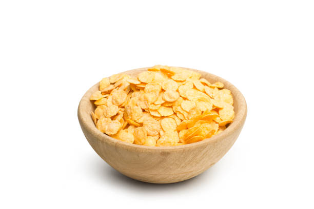 istock Corn flakes in a wooden bowl on a white background 1459332108