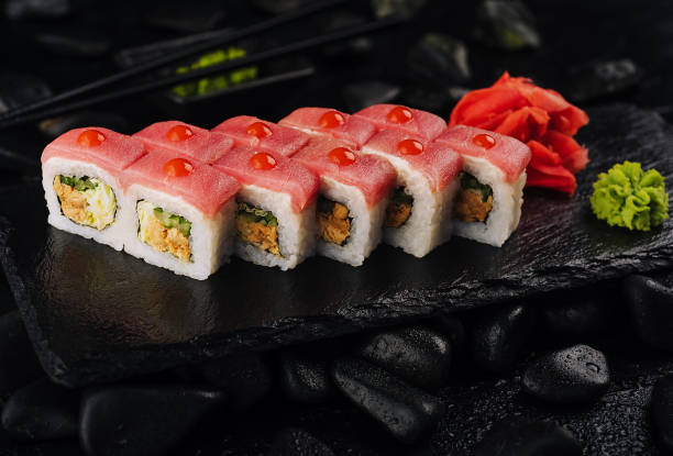 istock Japaneese food, tuna sushi rolls on stone board 1459332962
