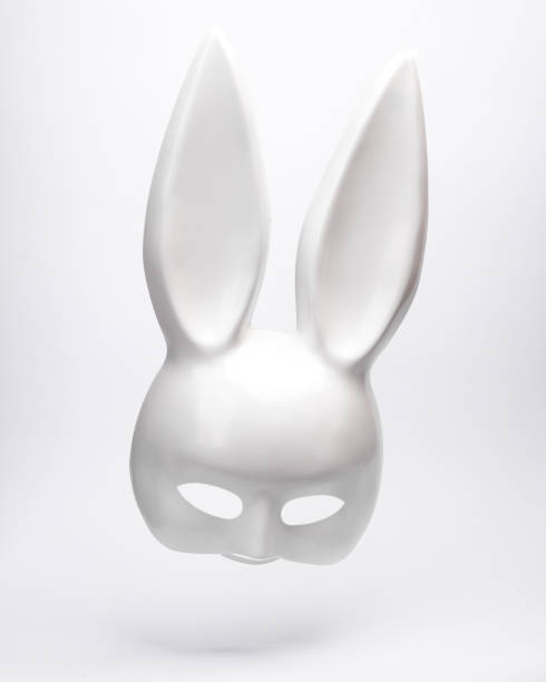 istock Plastic bunny mask levitating on white background with shadow. Minimal concept 1459334745