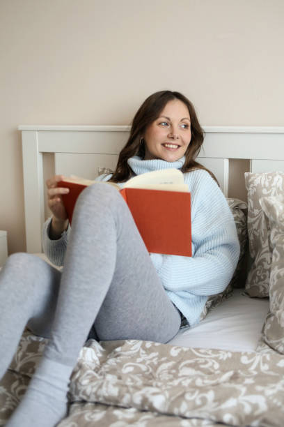 istock Pregnant woman reading a book 1459334895