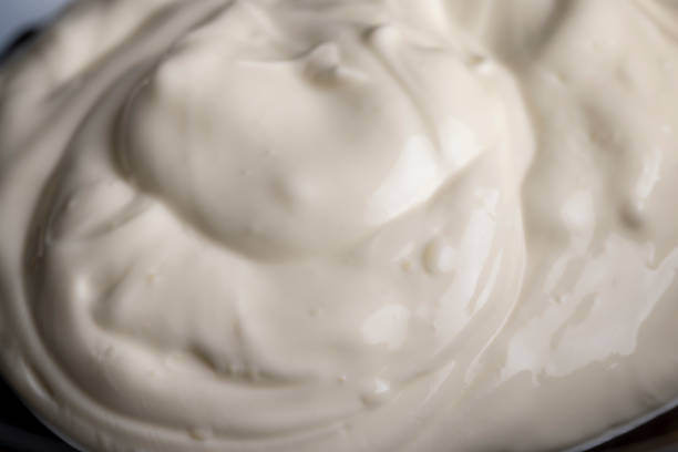 istock White fresh sour cream in a black glass plate 1459335183