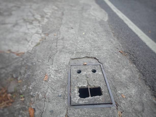 istock Human-faced concrete manhole cover 1459336734