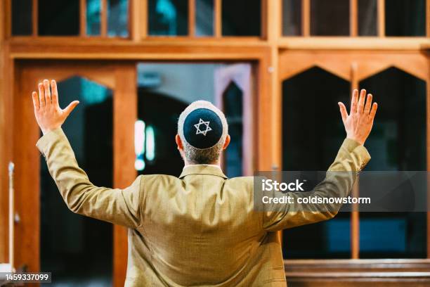 Celebrating Jewish Man With Arms Outstretched In Synagogue Stock Photo - Download Image Now