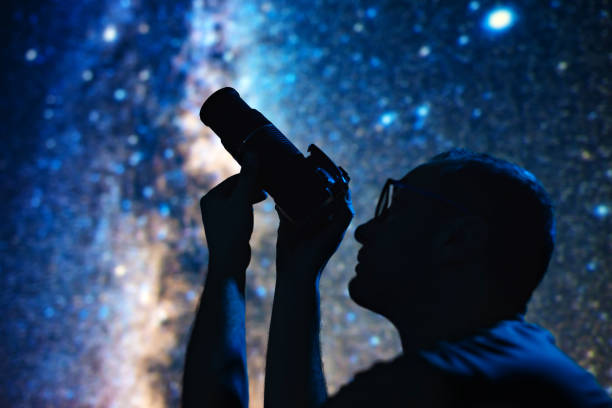 istock Astronomer photographing Milky Way night sky with a camera. 1459338701