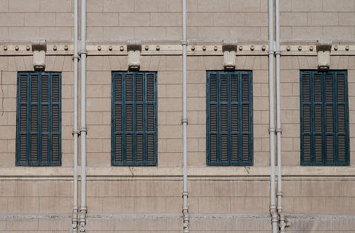 Row of windows with green  painted wood shutters in a courtyard at Al Abdeen royal palace in the centre of Cairo, Egypt