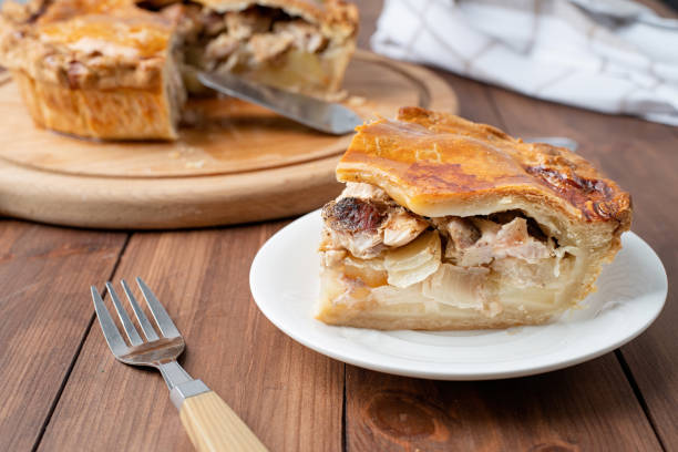 istock Homemade meat pie with greenery on wooden background 1459340668