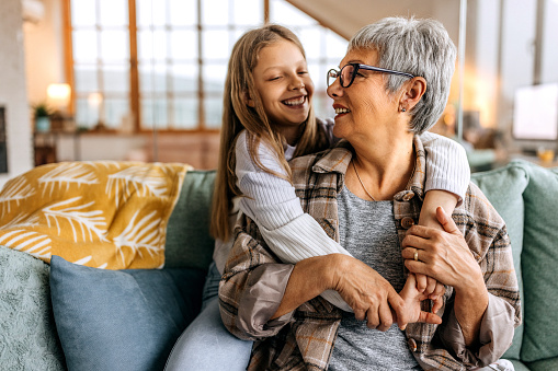 Grandmother and granddaughter bonding in a living room