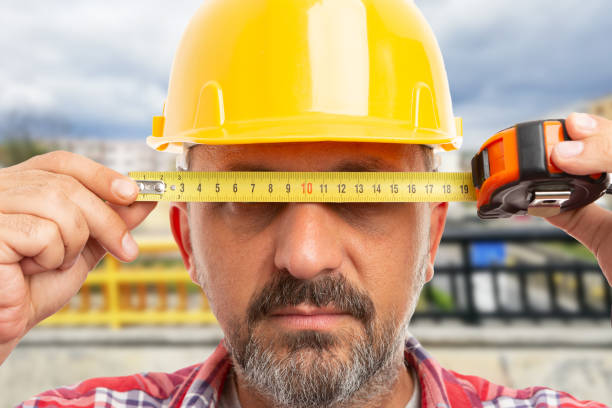 istock Close-up of man holding ruler over eyes 1459346789