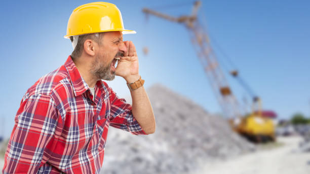 istock Close-up of worker making sound amplification gesture with hands 1459346896