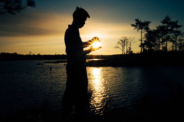 istock Catching the Sun at sunrise time from a man's hand. 1459349352