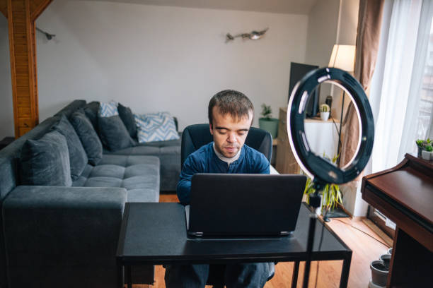 istock Young man with dwarfism working from home 1459351024