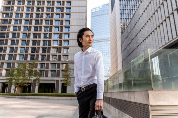 istock Seriously handsome businessman looking over shoulder 1459351322