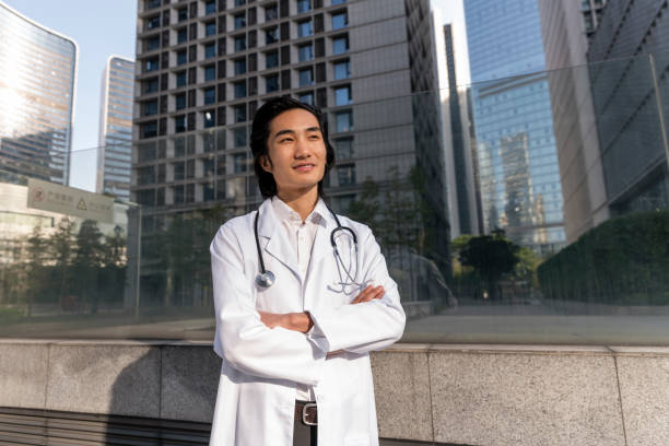 istock Smiling doctor looking away with arms crossed. 1459351728
