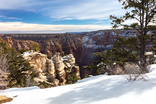 Hiker Passing Through Snow Covered Tunnel Along Bright Angel Trail in Grand Canyon National Park