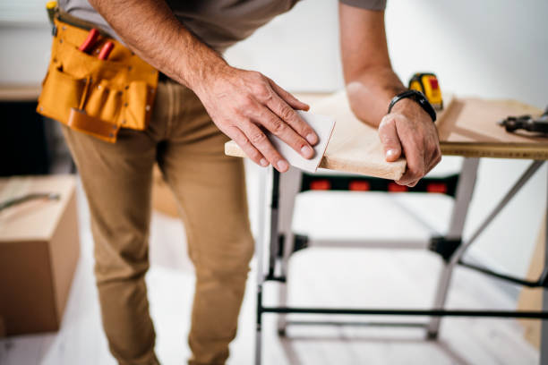 Sanding and smoothing wood with sandpaper.