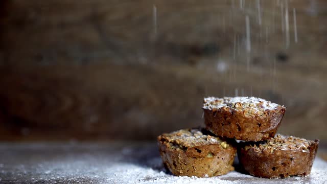 Fresh muffins banana with wooden background shallow focus with falling flour and copy space. healthy bread banana cupcakes