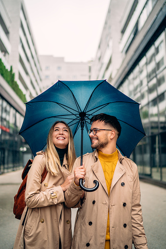 Silhouette couple prewedding under umbrella at sunset