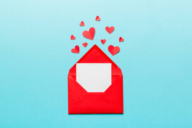 istock Red paper envelope with empty white card and heart on colored background. top view valentines day concept 1459360547