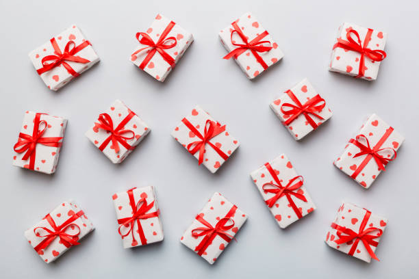 istock Valentine day composition Background: red gift box with bow and heart. Christmas present. View from above. Holday greeting card 1459360592