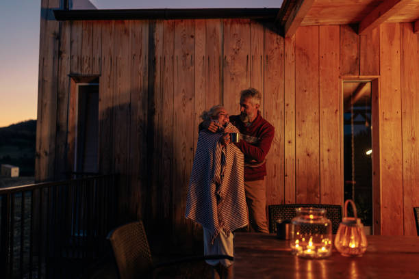 istock Romantic senior couple at mountain house. 1459360759