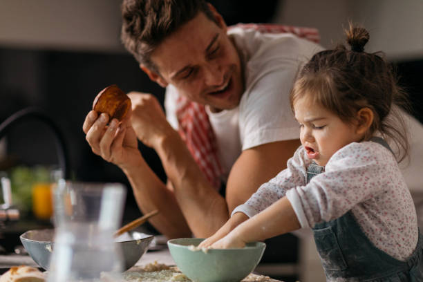 istock Father and daughter cooking at home 1459361219