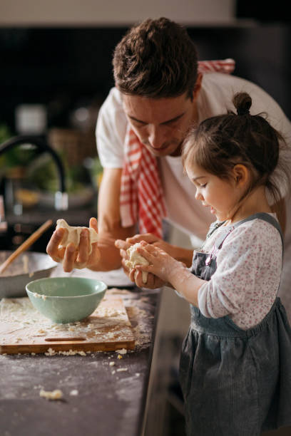 istock Cute girl and her dad in the dining room 1459361237