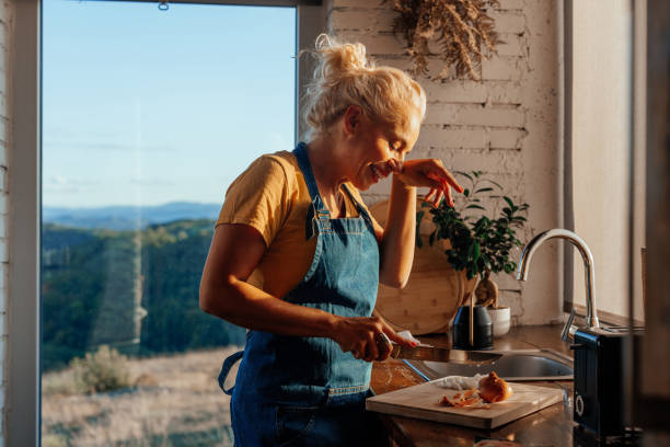istock Woman cutting onions in kitchen. 1459362541