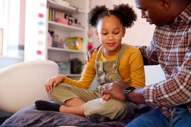 istock Father Comforting Sad Daughter Sitting On Bed At Home 1459363067