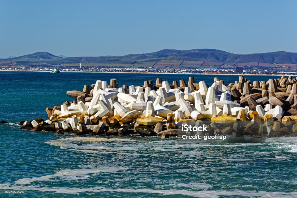 Breakwater made from concrete dolos blocks Wave dissipating breakwater made from large concrete dolos blocks designed by South African harbour engineer in 1963 and now used worldwide 1963 Stock Photo