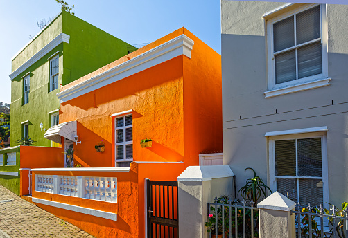 Street with Brightly coloured green and orange homes in historical tourist area of Bo-Kaap, Cape Town, Western Cape, South Africa