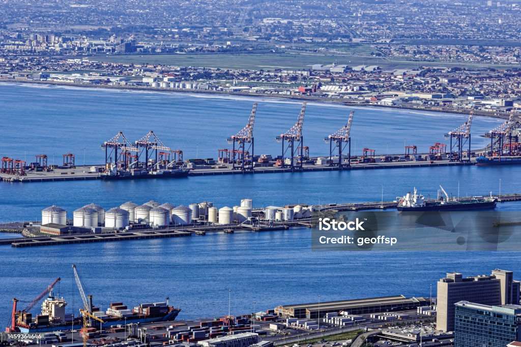 Cape Town docks with Milnerton in background Cape Town docks taken from Signal Hill showing ships unloading, container cranes, fuel storage tanks with the suburb of Milnerton in background Western Cape Province Stock Photo