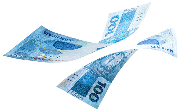 banknotes of one hundred reais from brazil falling on isolated white background. Fall of the Brazilian currency, devaluation, economic crisis. stock photo